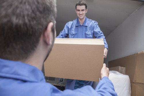 Packed boxes and furniture prepared for transport by removal staff