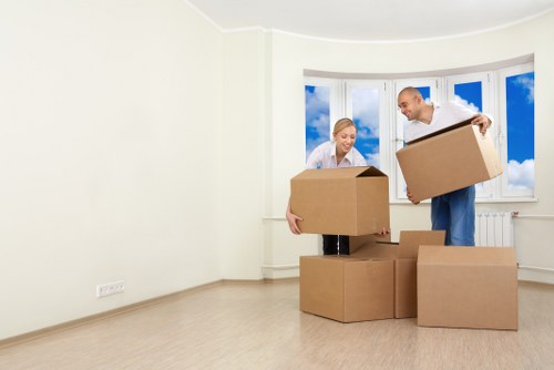 Furniture pick-up service helping remove a sofa from a Kentishtown home