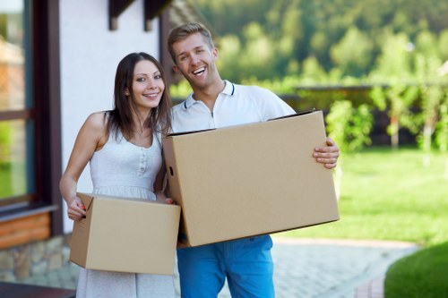 Movers handling furniture and boxes in a Kentishtown home