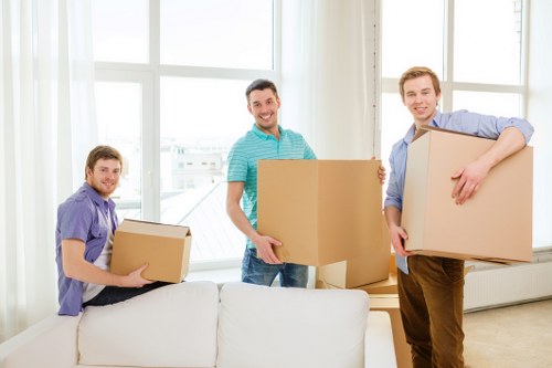Commercial removals team moving office equipment and furniture