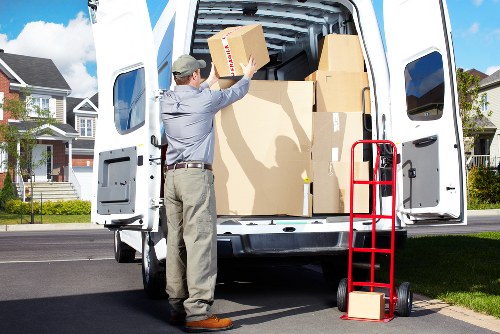 Local movers handling boxes and furniture in a Kentishtown flat